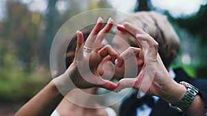 Romantic kiss between just married couple - Middle Eastern Ethnic Bride and Caucasian Groom. Blurred hands creating