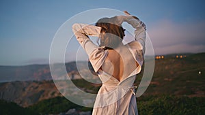 Romantic lady dancing sunset nature making relaxed movements on ocean cliff