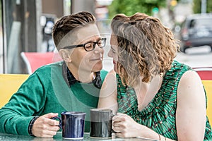 Romantic lesbian couple at bistro outdoors photo