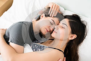 Romantic LGBT women looking calm and serene while sleeping