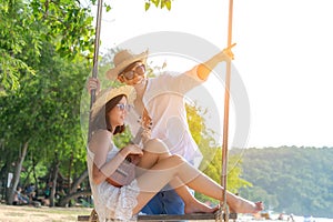 Romantic lifestyle asian couples lover playing an ukulele on the hammock. relax