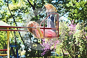 Romantic little girl on the swing, sweet dreams. Small kid playing in summer. childhood daydream .teen freedom