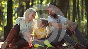 Romantic and love. Family autumn day. Smiling couple with kid having fun in autumn park. Happy family. Happy young