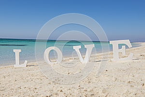 Romantic love sign on a tropical beach paradise