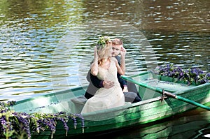 Romantic love story in boat. Woman with wreath and white dress. European tradition