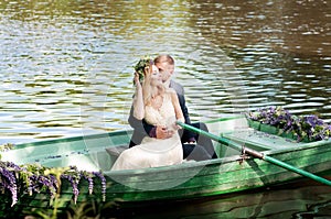 Romantic love story in boat. Woman with wreath and white dress. European tradition