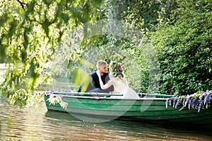 Romantic love story in boat. Woman with wreath and white dress. European tradition