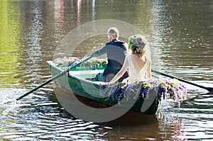 Romantic love story in boat. Woman with wreath and white dress. European tradition