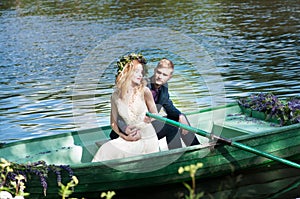 Romantic love story in boat. Woman with wreath and white dress. European tradition