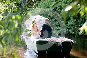 Romantic love story in boat. Woman with wreath and white dress. European tradition