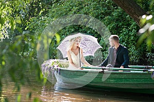 Romantic love story in boat. Woman with wreath and white dress. European tradition