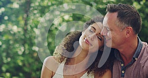 Romantic, loving and caring couple in love, happy and smiling while enjoying a date outside in summer. Married husband