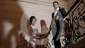 romantic loving couple on beautiful staircase in luxury interior hotel or palace