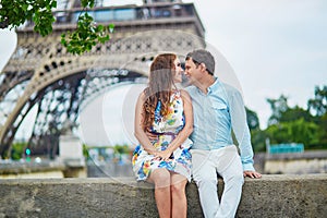 Romantic loving couple having a date near the Eiffel tower