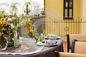 Romantic luxury evening on restaurant terrace decorated and table served with flowers and candles for wedding romantic dinner