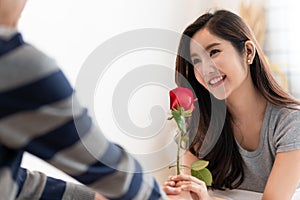 Romantic Man giving a rose to beautiful woman