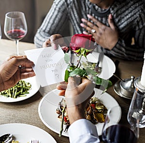 Romantic Man Giving a Rose to Woman on a Date