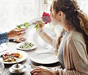 Romantic Man Giving a Rose to Woman on a Date