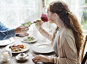 Romantic Man Giving a Rose to Woman on a Date