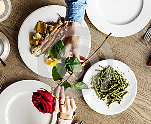 Romantic Man Giving a Rose to Woman on a Date