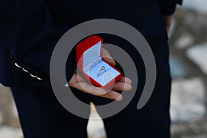 Romantic man making a marriage proposal. picture of man with gift box in suit. picture of couple with wedding ring and gift box.