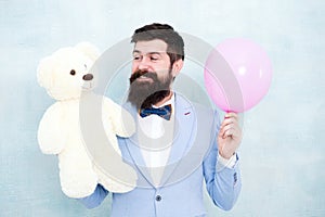 Romantic man with teddy bear and party balloon. surprise for his girlfriend. holiday celebration concept. romantic man