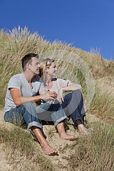 Romantic Man & Woman Couple Sitting On Beach