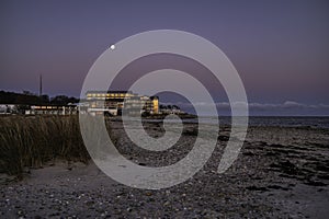 the romantic Marienlyst beach hotel in moonlight during the twilight hour