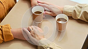 Romantic married couple holding hands on date in cafe. Love, relationship, togetherness and lifestyle concept