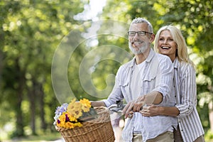 Romantic Mature Couple Riding Bicycle Outdoors And Having Fun Together