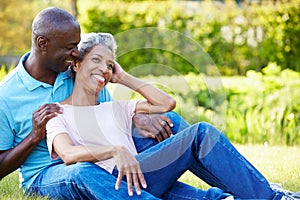 Romantic Mature Couple Sitting In Garden