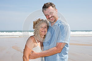 Romantic Middle Aged Couple Enjoying Beautiful Sun Walk on the Beach