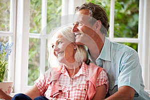 Romantic Middle Aged Couple Looking Out Of Window