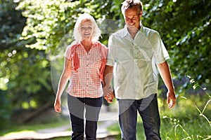 Romantic Middle Aged Couple Walking Along Countryside Path