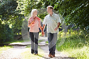 Romantic Middle Aged Couple Walking Along Countryside Path