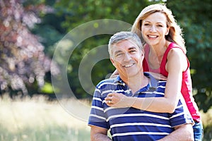 Romantic Middle Aged Couple Walking In Countryside