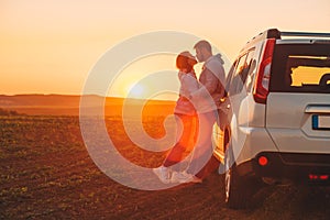 romantic moment couple kissing on sunset near white suv car