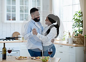 Romantic Moments. Young Happy Black Couple Dancing Together In Kitchen