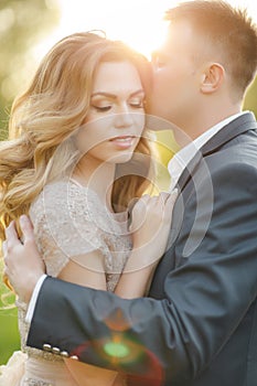 Romantic moments of a young wedding couple on summer meadow