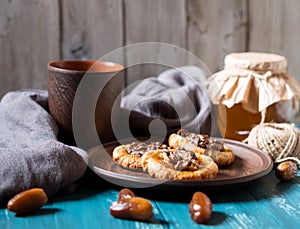 Romantic morning still life, in a rustic style with cookies, a glass jar of honey