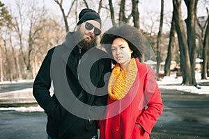 Romantic multiethnic couple in love hugging on the street