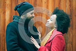 Romantic multiethnic couple in love hugging on the street