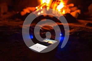 Romantic music listening near a campfire