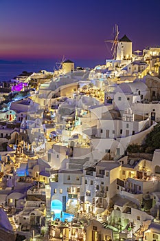 Romantic night view of traditional Greek village Oia on Santorini island in Greece. Santorini is iconic travel destination in