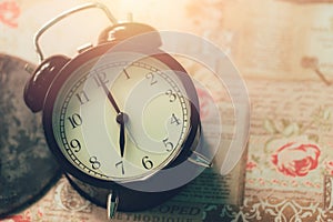 Romantic old clock on table time at 7 o`clock in the morning