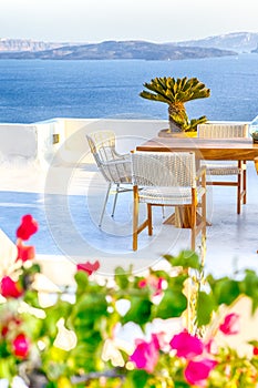 Romantic Open Air Cosy Terrace Restaurant in Beautiful Oia Village on Santorini Island in Greece Before the Sunset