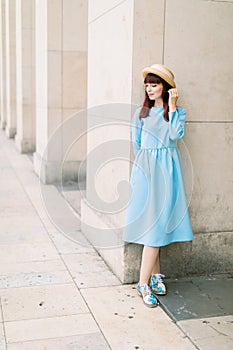 Romantic outdoor beautiful girl portrait on the background of architechture columns in ancient European city. Pretty