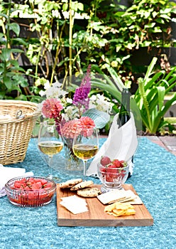 Romantic patio setting for relaxing warm summer evening outdoor picnic in beautifully landscaped garden