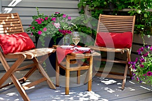 Romantic patio setting for relaxing warm summer evening outdoor picnic in beautifully landscaped garden