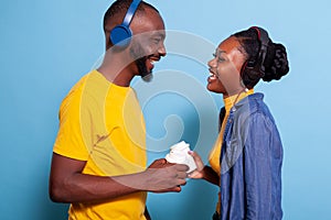 Romantic people having fun with radio music on headphones